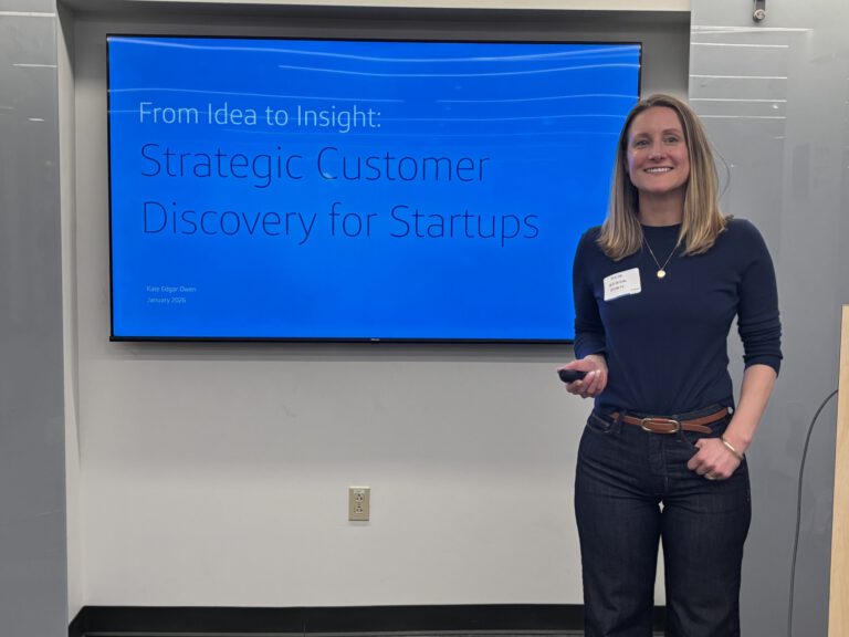 Kate Edgar Owen presenting in front of a screen